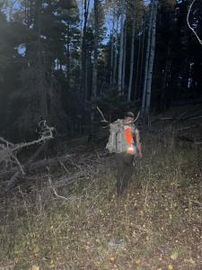 Hiker with Elk antlers in forest